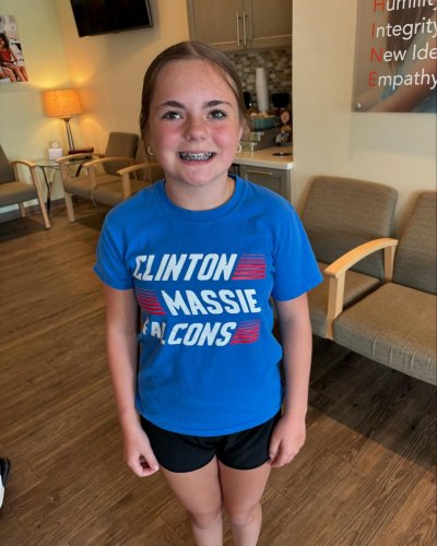 Girl smiling showing her braces 