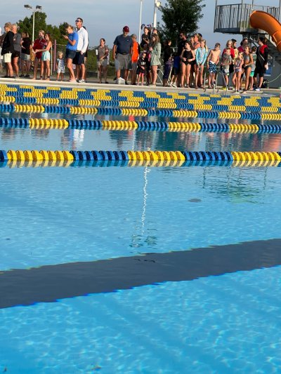 People standing around pool
